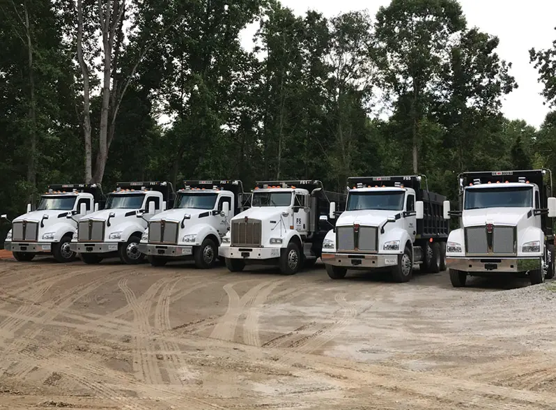 Dump trucks staged and ready to haul for TruckStone Logistics